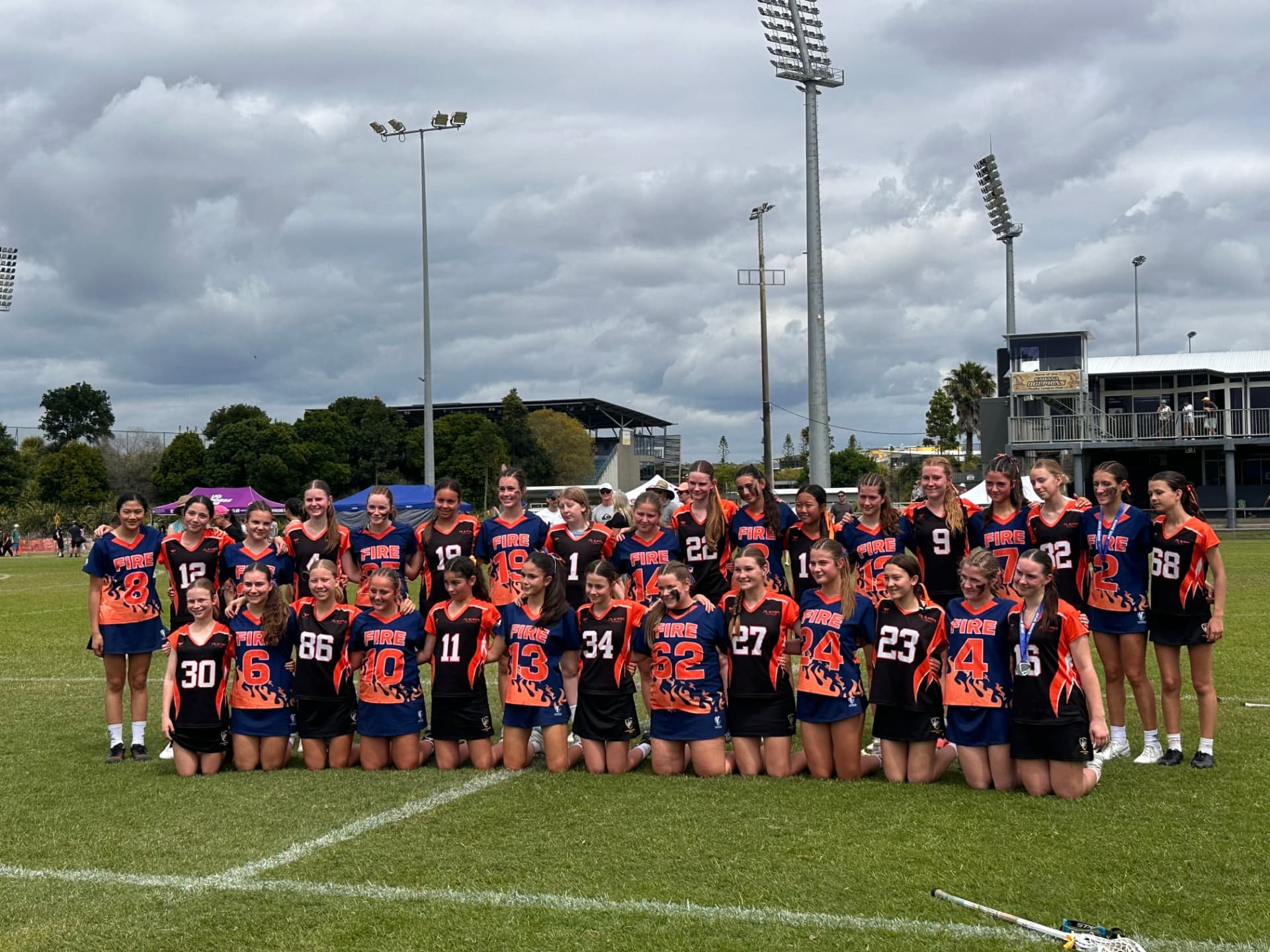 A large group photo of FIRE players with another team on the field.