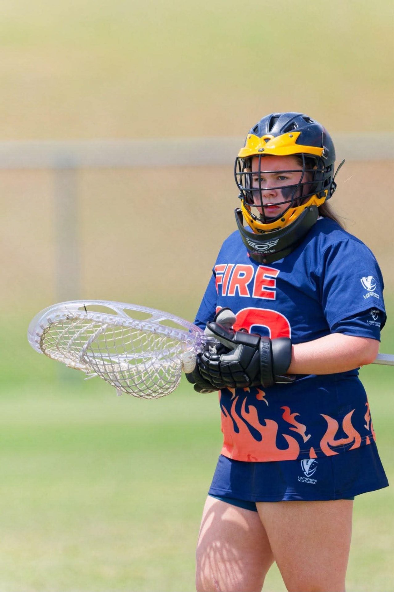 Ivy in goal for FIRE, holding her goalie stick ready.