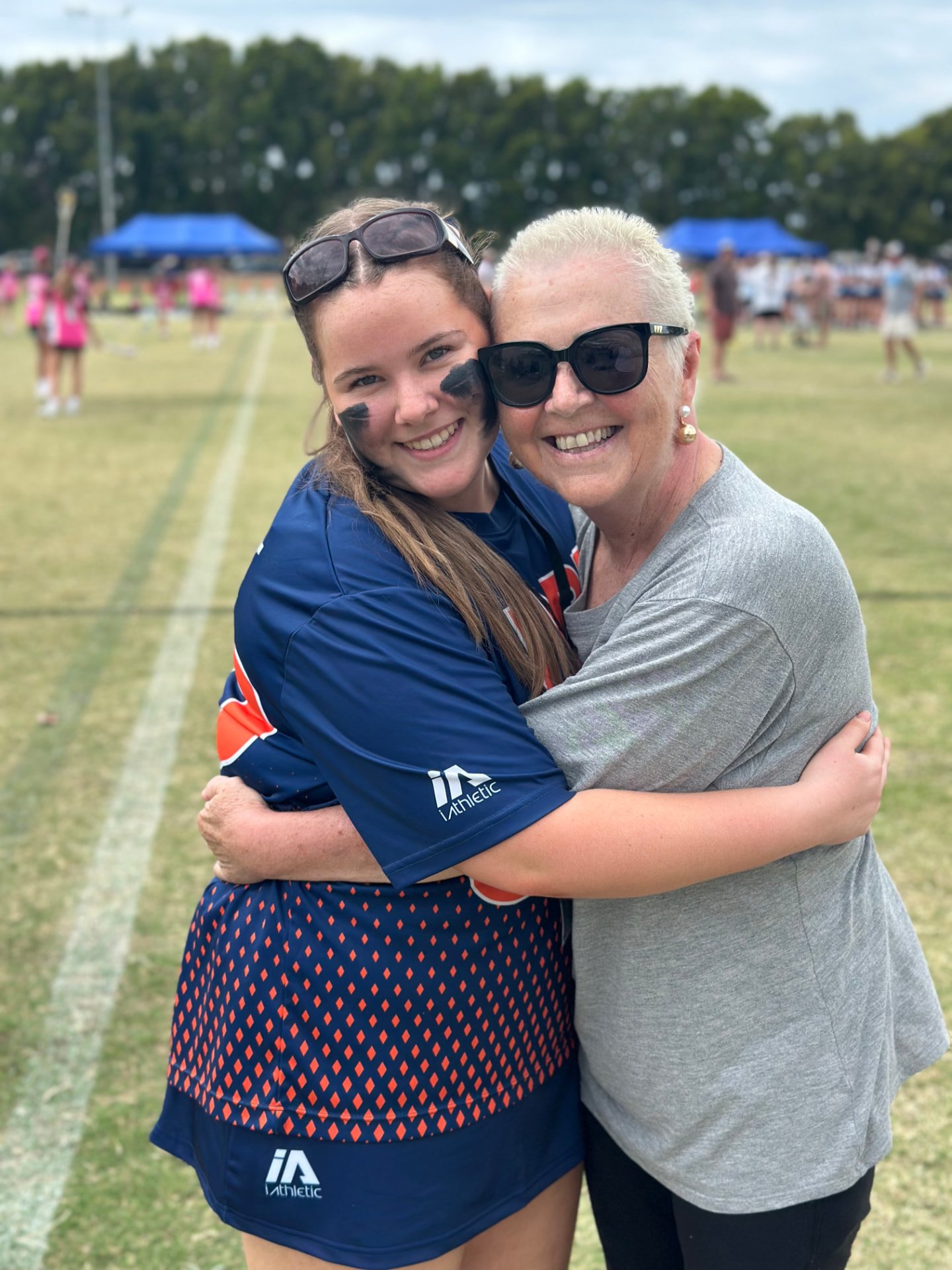 Ivy hugging a supporter at the tournament ground.