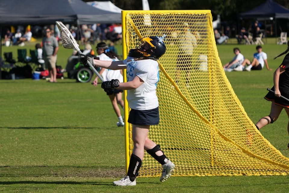 Ivy Merritt clearing the ball at the 2025 U15 National Tournament in Perth.
