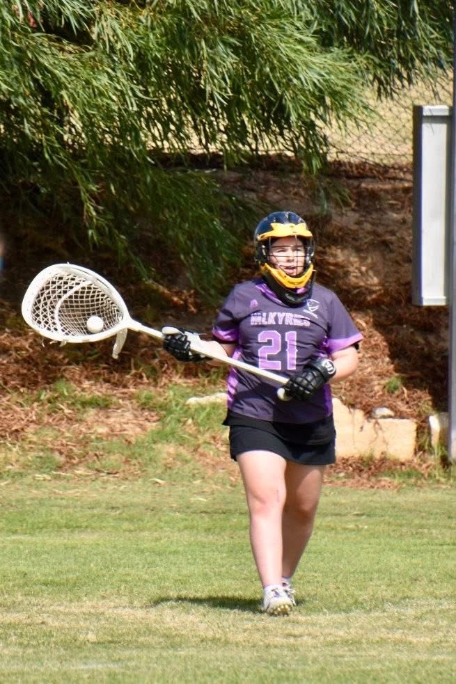Ivy Merritt passing the ball out of defence.